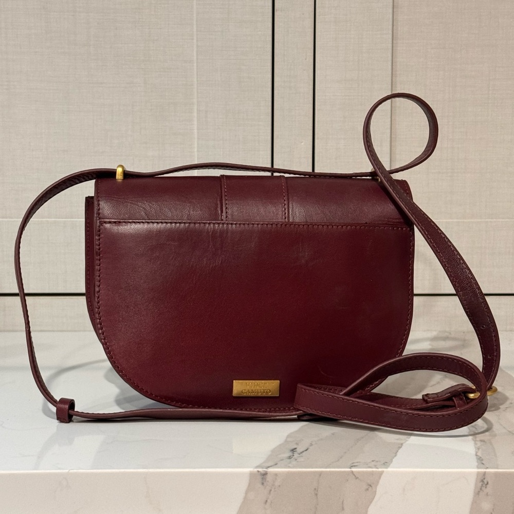 Burgundy leather Vince Camuto handbag with shoulder strap.